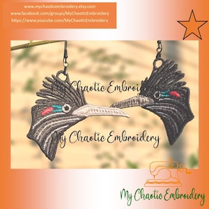 May include: A pair of embroidered earrings shaped like bird heads, featuring black thread with white, red, and blue accents. The birds have prominent crests and long, pointed beaks. Each earring hangs from a black metal hook, displaying detailed stitching.