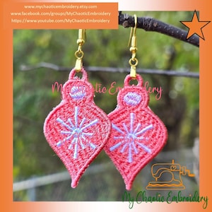 May include: A pair of red embroidered teardrop-shaped earrings with a snowflake design in light blue. The earrings have gold-colored hooks. The text "My Chaotic Embroidery" is visible.