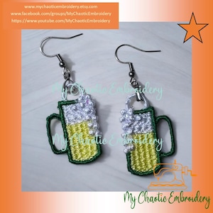 May include: A pair of silver earrings with a green beer mug charm. The mug is filled with a white foam and yellow liquid. The earrings are a fun and festive accessory for any occasion.