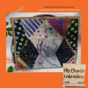 May include: A colorful patchwork fabric coaster with a geometric design. The coaster is framed with a wooden border and has a small sign that reads "My Chaotic Embroidery".
