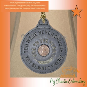 May include: A grey embroidered ornament with the text "YOU WERE NEVER ENOUGH ODE TO THE PENNY YET ALWAYS THERE". A penny is in the centre. The ornament has a gold cord for hanging. The Etsy shop name is visible.