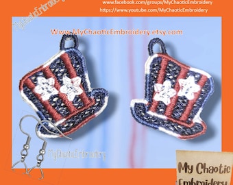May include: A pair of red, white, and blue Uncle Sam hat-shaped earrings. The earrings are made of embroidered fabric and have a silver hook closure. The earrings are on a light blue background. The text "My Chaotic Embroidery" is visible in the image.