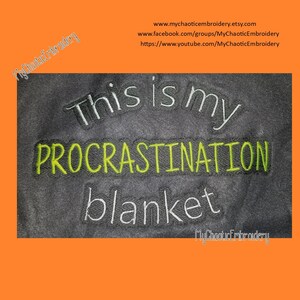 May include: A grey blanket with the text "This is my procrastination blanket" embroidered in white and green thread.