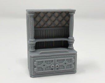 May include: A gray wooden cabinet with a decorative lattice design on the top and two doors on the bottom. The cabinet has a shelf in the middle.
