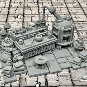May include: A miniature tabletop set for a fantasy role-playing game, featuring a gray wooden table with a mortar and pestle, a large glass flask, and a collection of books and bottles.