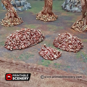 May include: A set of three bone pile terrain pieces for tabletop gaming. The piles are made of a light brown plastic and are covered in a red paint to simulate blood. The piles are different sizes and shapes, and they are all very detailed.