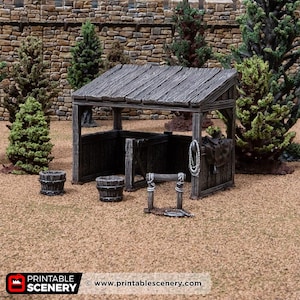 May include: A miniature wooden stable with a weathered look, featuring a sloped roof and open sides. Two small wooden buckets and a water trough are in front. A rope and saddle hang on the side. The scene is set against a backdrop of trees and a stone wall.