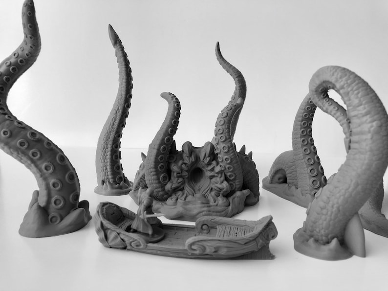 May include: A set of gray 3D printed miniature octopus tentacles and a small boat. The tentacles are curled and have suction cups. The boat is a simple design with a figure of a person in it.