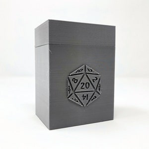 May include: A gray plastic box with a 20-sided die design on the front. The die has numbers 1 through 20 printed on it.