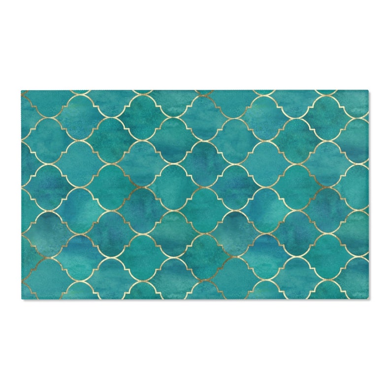 May include: A teal blue and gold geometric pattern with a watercolor effect. The pattern is made up of repeating shapes that resemble quatrefoils.