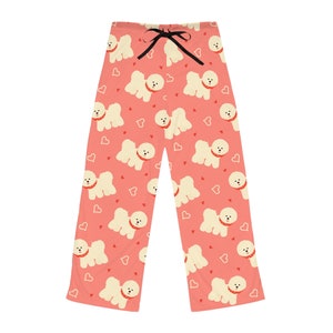 May include: Coral-colored pajama pants with a repeating pattern of cartoon dogs wearing red collars and small red hearts. The pants have a black drawstring at the waist.