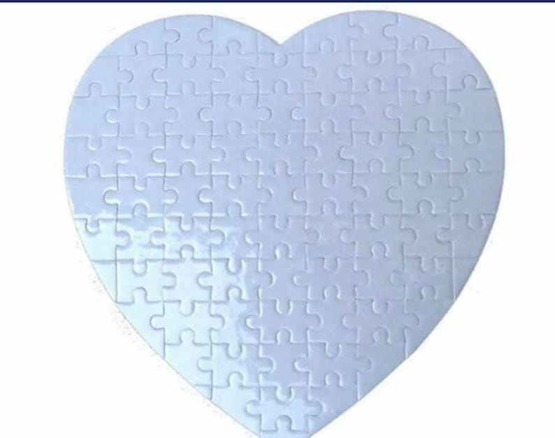 May include: A white heart-shaped puzzle with a smooth, glossy finish. The puzzle is made up of many small pieces, each with a unique shape.
