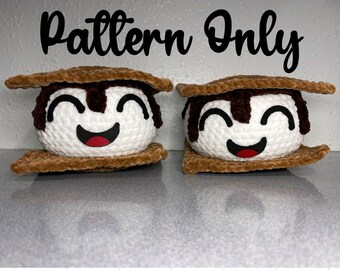 May include: Two crocheted s'mores with smiling faces. The s'mores are made of brown yarn for the graham crackers, white yarn for the marshmallow, and brown yarn for the chocolate.