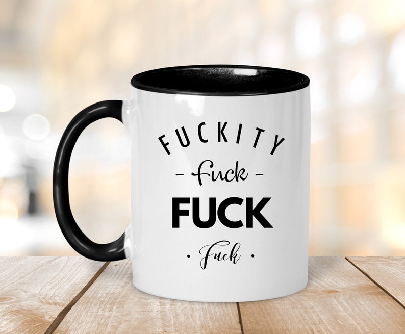 May include: White coffee mug with a black rim and handle. The mug has black text that reads "F*CKITY -f*ck- F*CK .f*ck."