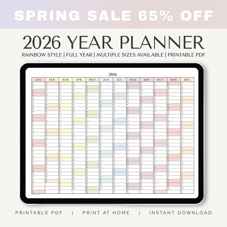 May include: A digital tablet displays a 2026 year planner with a rainbow style design. The calendar grid is filled with pastel colors, and the text "SPRING SALE 65% OFF" is at the top. The planner is available in multiple sizes as a printable PDF.