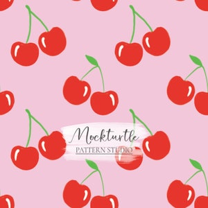 May include: A seamless pattern featuring red cherries with green stems on a pink background. The text "Mockturtle PATTERN STUDIO" is written in black on a white brushstroke.
