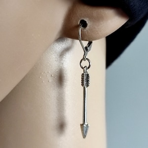 May include: Silver arrow earrings with a simple design. The earrings are made of metal and have a hook fastening.