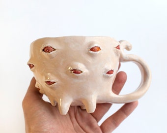 Whimsical Ceramic white mutant cup with red eyes, sculptural monster cup with paws handmade unique cup, creepy mug
