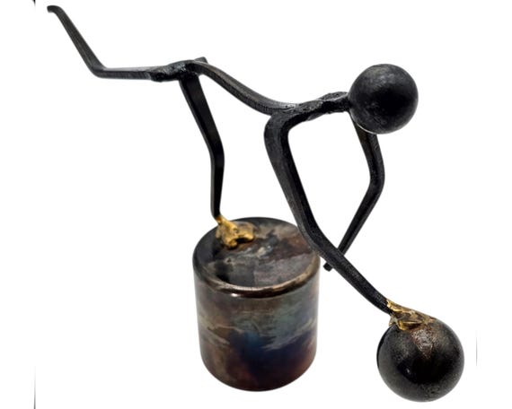 A torch-welded nail sculpture from the 1970s Brutalist studio craft era — a balancing bowler figure that's genuinely one-of-a-kind vintage metalwork.