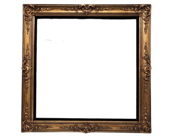 May include: A gold-colored ornate picture frame with a black mat.