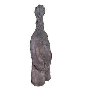 May include: A dark gray ceramic sculpture of a human figure with a stylized head and a twisted, rope-like neck.