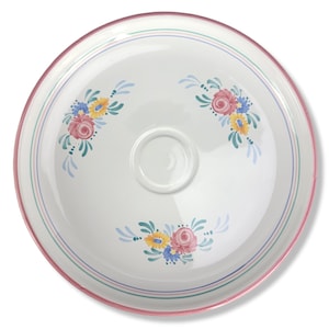May include: A white ceramic serving plate with a pink rim and floral design. The plate features a central recessed area and is decorated with colorful flowers in pink, yellow, and blue, with green leaves and blue accents. The plate has a diameter of approximately 12 inches.