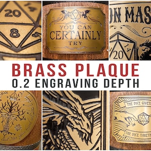 May include: A close-up of six different brass plaques with various designs, including a dragon, a tree, a dice, and a hand reaching towards a dice. The plaques are engraved with the text "You Can Certainly Try", "Dragon Master", and "The Dice Giveth and The Dice Taketh Away". The plaques are 0.2 inches deep.