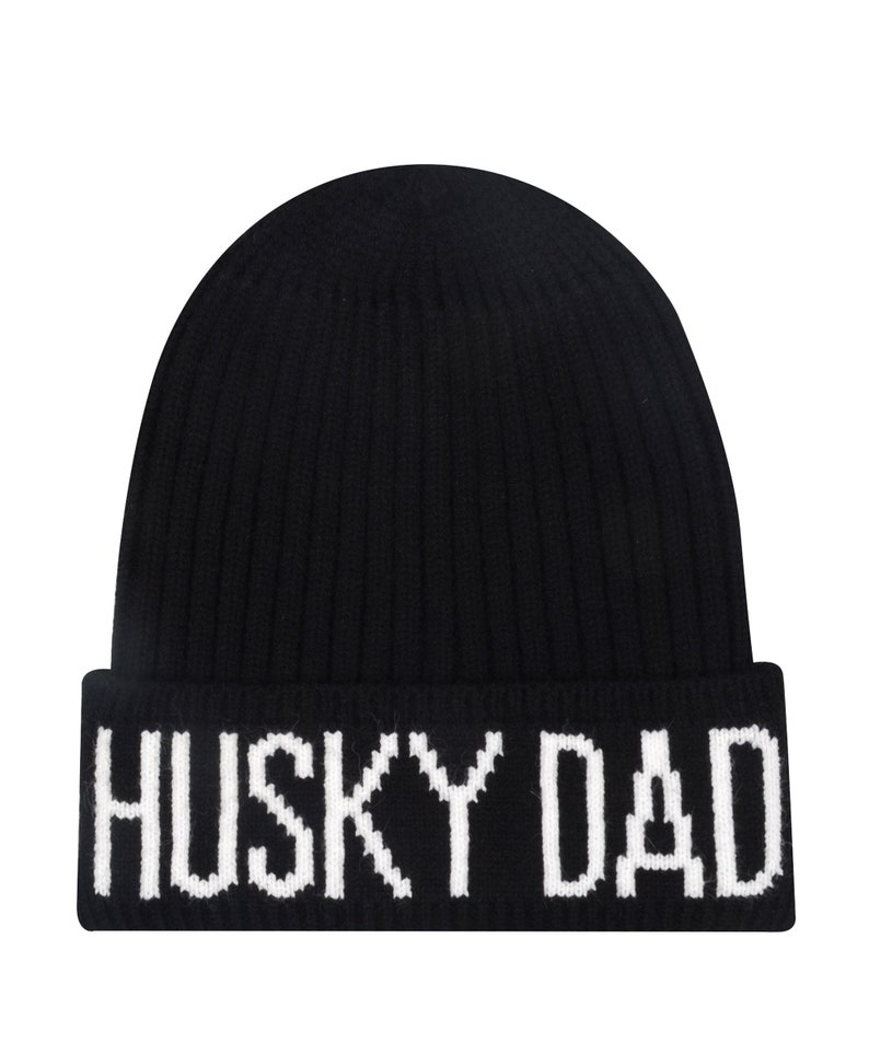 May include: Black knitted beanie with a white "HUSKY DAD" embroidered across the bottom.