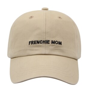May include: A beige baseball cap with black embroidered text that reads "FRENCHIE MOM".