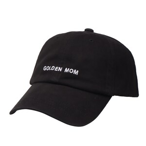 May include: Black baseball cap with white embroidered text that reads "GOLDEN MOM".