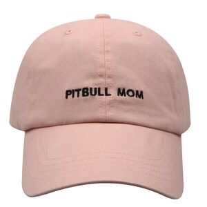 May include: A pink baseball cap with black embroidery that reads "PITBULL MOM".