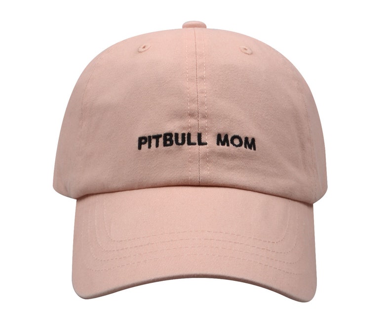 May include: A pink baseball cap with black embroidery that reads "PITBULL MOM".