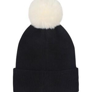 May include: Black knit beanie with a white faux fur pom pom on top.