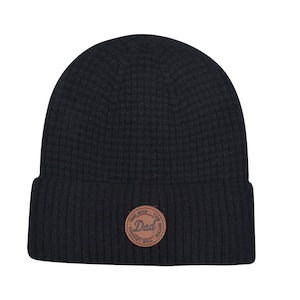 May include: Black knit beanie with a brown leather patch that says "The Man, The Myth, The Dad" in a circle.