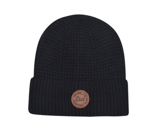 May include: Black knit beanie with a brown leather patch that says "The Man, The Myth, The Dad" in a circle.