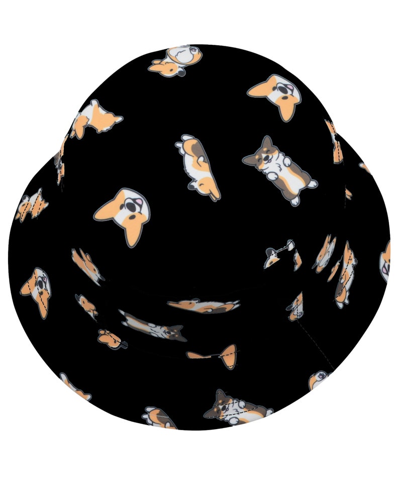 May include: Black bucket hat with a repeating pattern of cartoon corgis in various poses. The corgis are brown, white, and orange.