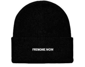 May include: A black beanie with the text "FRENCHIE MOM" in white, centered on the folded brim. The hat is made of a soft, knitted material, suitable for cold weather.