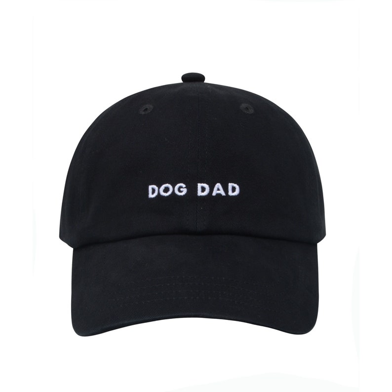 May include: A black baseball cap with white embroidery that reads "DOG DAD".