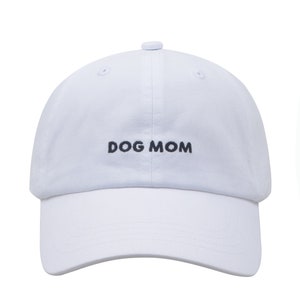 May include: White baseball cap with black embroidery that reads "DOG MOM".