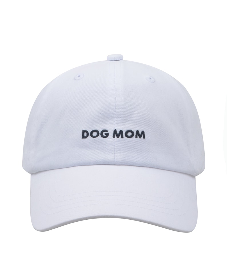 May include: White baseball cap with black embroidery that reads "DOG MOM".