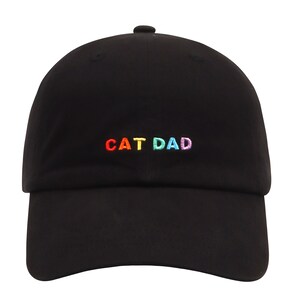May include: Black baseball cap with a rainbow embroidered "CAT DAD" on the front.