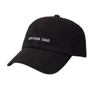 May include: Black baseball cap with a white embroidered phrase "GOLDEN DAD" on the front.