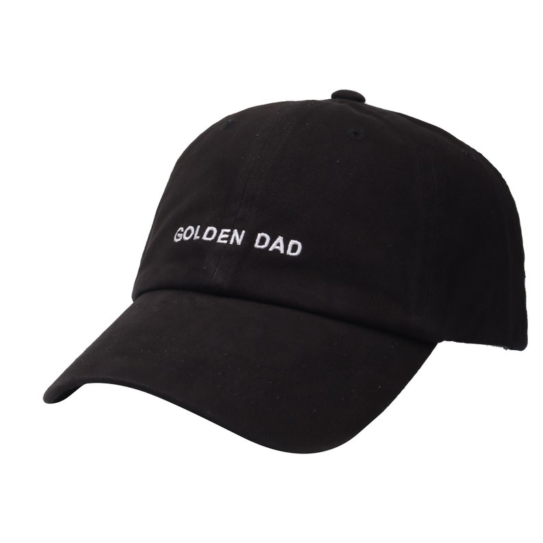May include: Black baseball cap with a white embroidered phrase "GOLDEN DAD" on the front.