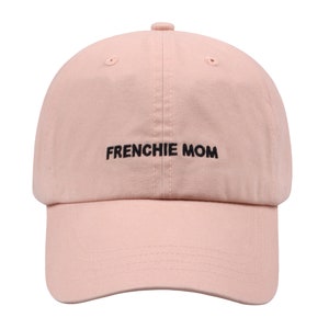 May include: A pink baseball cap with black embroidery that reads "FRENCHIE MOM".