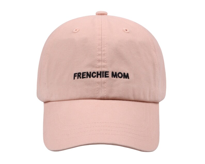 May include: A pink baseball cap with black embroidery that reads "FRENCHIE MOM".
