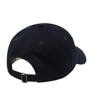 May include: A black baseball cap with a curved brim and an adjustable buckle closure.