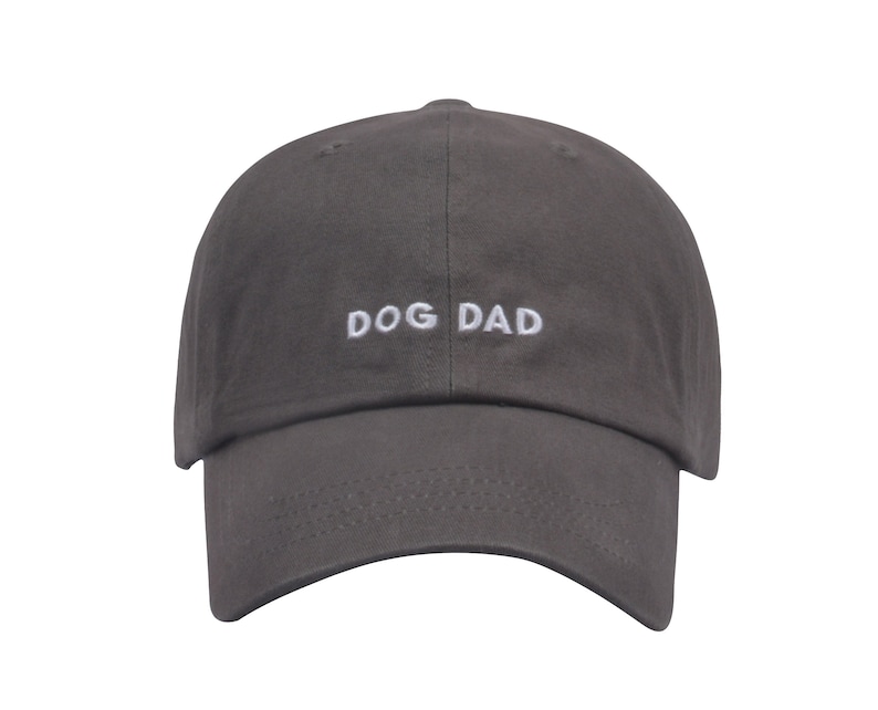 May include: A gray baseball cap with the text "DOG DAD" embroidered in white on the front.