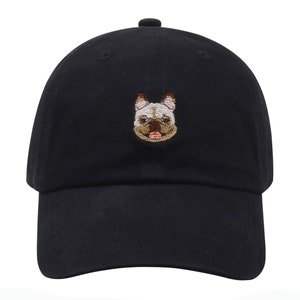 May include: A black baseball cap with an embroidered image of a French bulldog on the front.