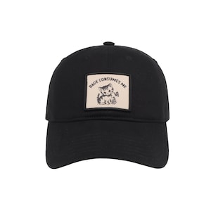 May include: Black baseball cap with a curved brim. A square patch on the front features a cartoon kitten illustration with the text "Rage Consumes Me". The cap is made of a soft, durable fabric and has a button on top.