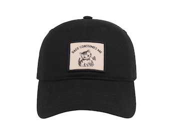 May include: Black baseball cap with a curved brim. A square patch on the front features a cartoon kitten illustration with the text "Rage Consumes Me". The cap is made of a soft, durable fabric and has a button on top.
